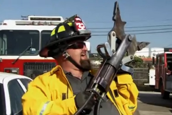 Ton Jones holds a Hurst Jaws of Life as he is dressed as fire fighter as seen on Auction Hunters.