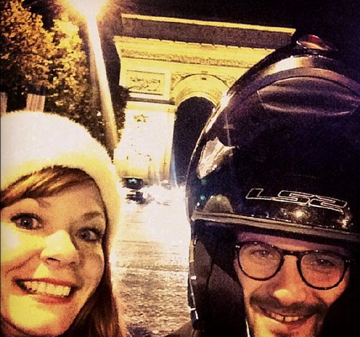 Candy Olsen at the Arc de Triomphe at night.