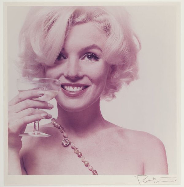 Drinks are on me. Marilyn Monroe semi-nude with drink in hand.