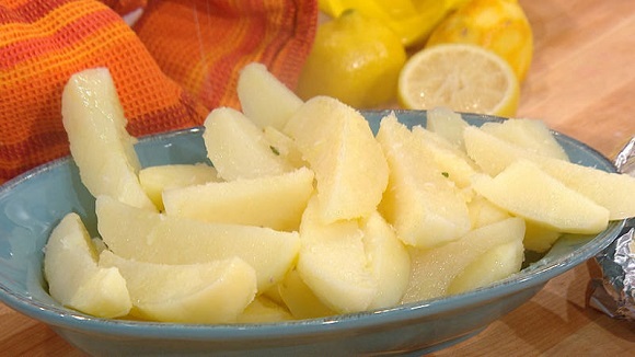 Bowl of lemon zest potato slices.
