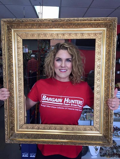 Case Nezhoda holds up picture frame.